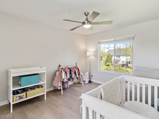 2303 Kentuck Ct, Naperville, IL 60564 - bedroom featuring wood finished floors, baseboards, a nursery area, and a ceiling fan