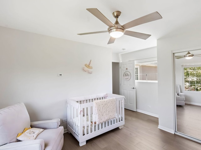 2303 Kentuck Ct, Naperville, IL 60564 - bedroom with wood finished floors, a crib, baseboards, and ceiling fan