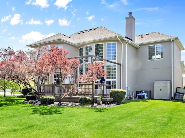 2303 Kentuck Ct, Naperville, IL 60564 - rear view of house with stucco siding, a chimney, and a lawn
