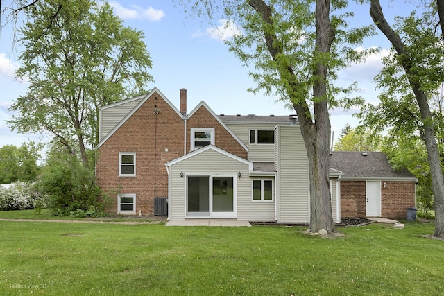 210 N Wheeling Rd, Prospect Heights, IL 60070 - back of property featuring a chimney, a lawn, brick siding, and central air condition unit