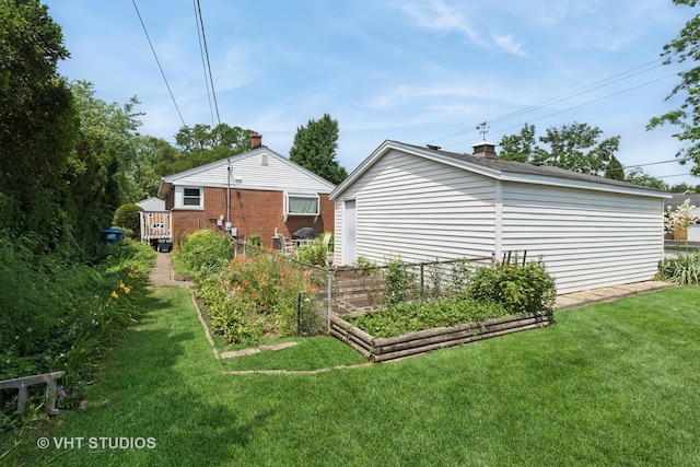 1401 S 6th Ave, Des Plaines, IL 60018 - back of house featuring a lawn, a vegetable garden, and a chimney
