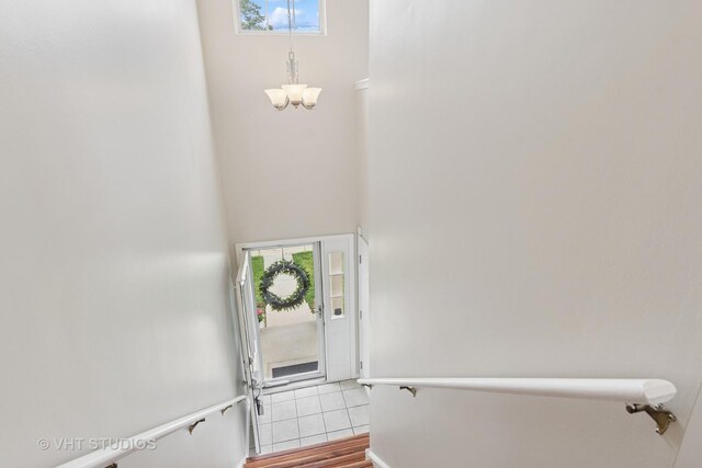 66 N Palazzo Dr, Addison, IL 60101 - stairs featuring a chandelier, a high ceiling, and wood finished floors