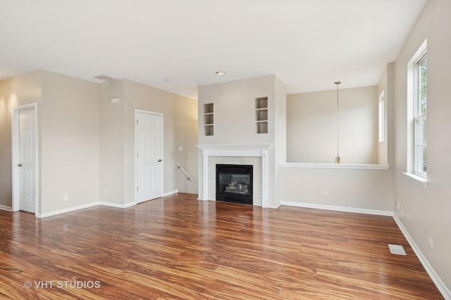66 N Palazzo Dr, Addison, IL 60101 - unfurnished living room with wood finished floors, baseboards, and a tile fireplace