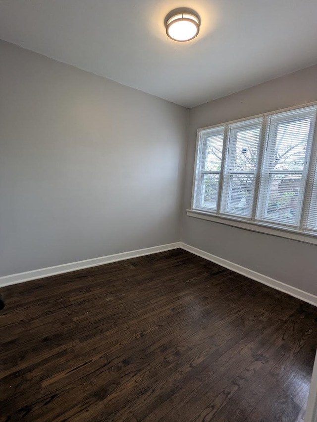 7545 S May St, Chicago, IL 60620 - spare room featuring dark wood-type flooring and baseboards