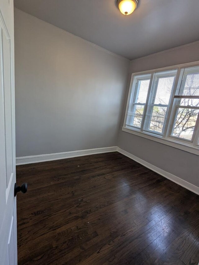 7545 S May St, Chicago, IL 60620 - unfurnished room with dark wood finished floors, baseboards, and crown molding