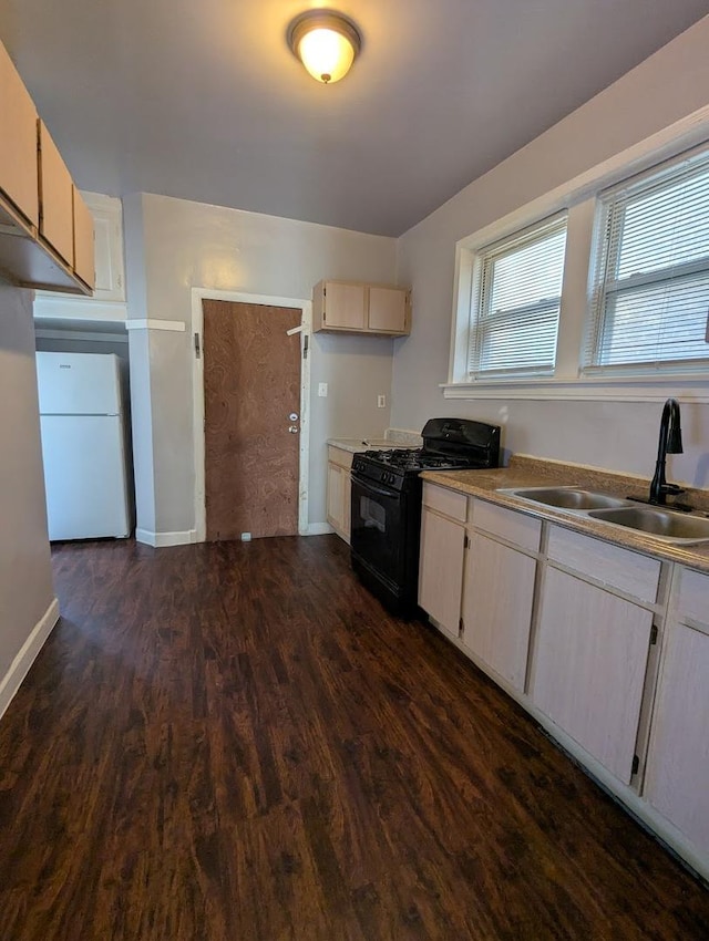 7545 S May St, Chicago, IL 60620 - kitchen featuring black gas stove, a sink, freestanding refrigerator, dark wood finished floors, and baseboards