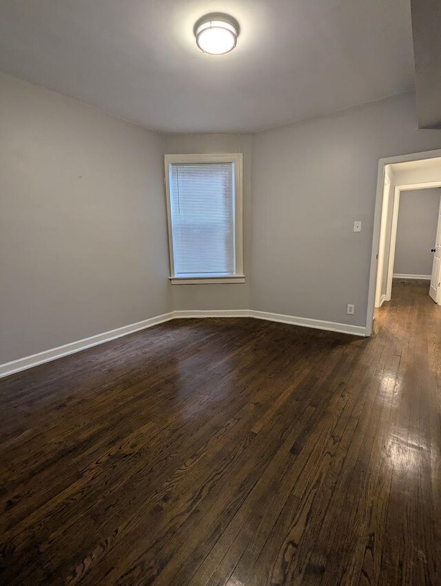 7545 S May St, Chicago, IL 60620 - unfurnished room with dark wood-style flooring and baseboards