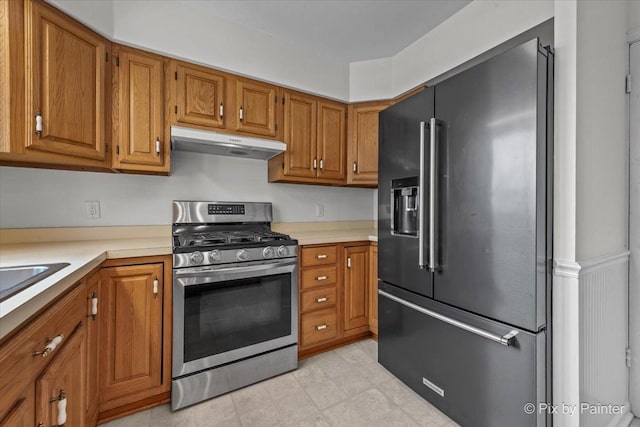 1315 W Galena Blvd, Aurora, IL 60506 - kitchen with under cabinet range hood, high end refrigerator, stainless steel range with gas cooktop, and brown cabinetry