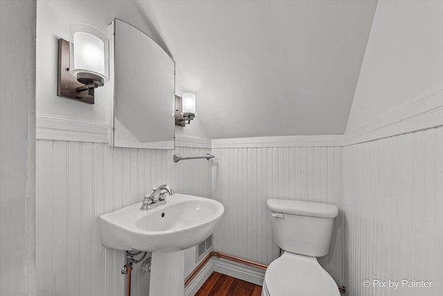 1315 W Galena Blvd, Aurora, IL 60506 - bathroom with lofted ceiling, a wainscoted wall, toilet, and wood finished floors