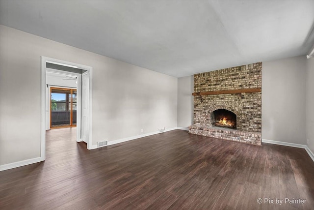 1315 W Galena Blvd, Aurora, IL 60506 - unfurnished living room with dark wood-style flooring, a brick fireplace, and baseboards