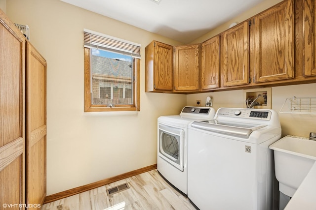 2950 Becket Ave, Westchester, IL 60154 - laundry room with independent washer and dryer, cabinet space, and baseboards