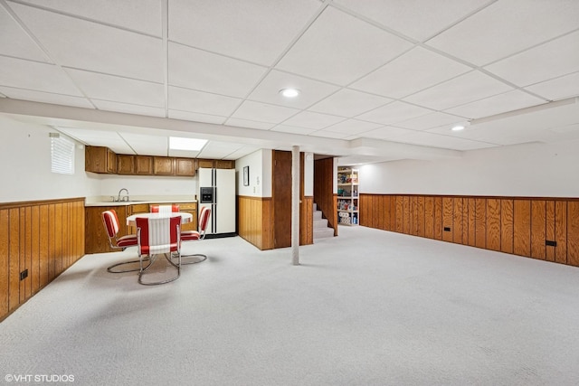2950 Becket Ave, Westchester, IL 60154 - kitchen featuring white refrigerator with ice dispenser, a wainscoted wall, wood walls, brown cabinets, and light carpet