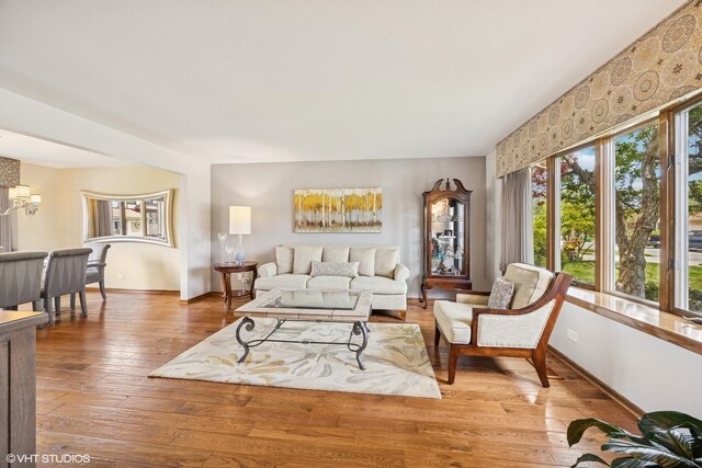 2950 Becket Ave, Westchester, IL 60154 - living room with light wood-type flooring, baseboards, and a chandelier