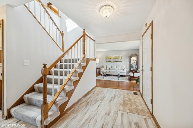 2950 Becket Ave, Westchester, IL 60154 - staircase with wood finished floors, baseboards, and a chandelier