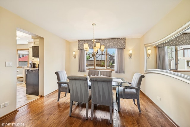 2950 Becket Ave, Westchester, IL 60154 - dining room featuring a chandelier, healthy amount of natural light, and wood finished floors