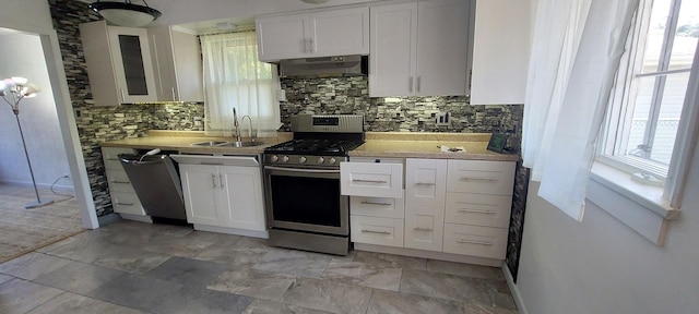 704 S Neltnor Blvd, West Chicago, IL 60185 - kitchen featuring stainless steel range with gas cooktop, a sink, under cabinet range hood, dishwashing machine, and white cabinets