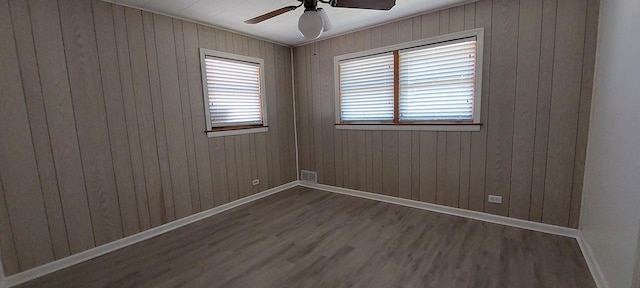 704 S Neltnor Blvd, West Chicago, IL 60185 - empty room featuring wood finished floors, ceiling fan, baseboards, and wood walls