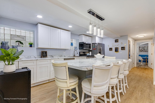 8027 S Green St, Chicago, IL 60620 - kitchen with appliances with stainless steel finishes, light wood finished floors, white cabinetry, light stone counters, and recessed lighting