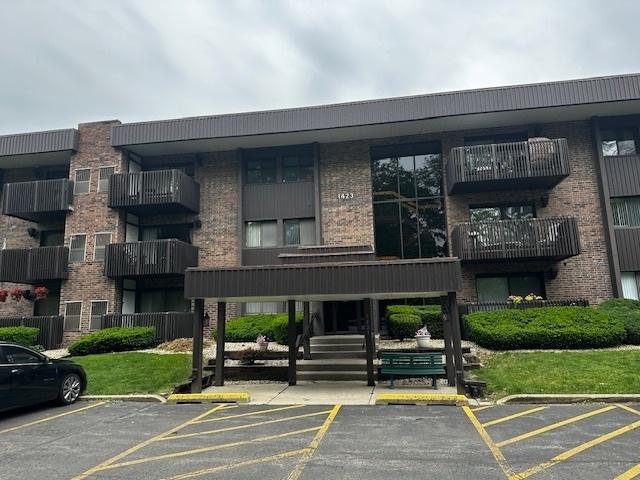 1423 Woodbridge Rd Unit 1F, Joliet, IL 60436 - view of apartment building / complex featuring uncovered parking