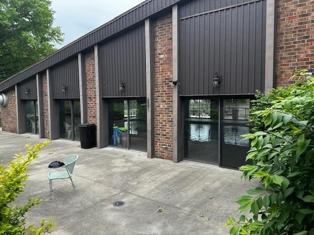 1423 Woodbridge Rd Unit 1F, Joliet, IL 60436 - doorway to property featuring brick siding and a patio area