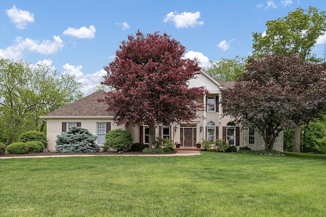 18089 W Pond Ridge Cir, Gurnee, IL 60031 - view of property hidden behind natural elements featuring a front yard, brick siding, and a shingled roof