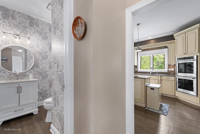 18089 W Pond Ridge Cir, Gurnee, IL 60031 - bathroom featuring wallpapered walls, vanity, toilet, wood finished floors, and baseboards