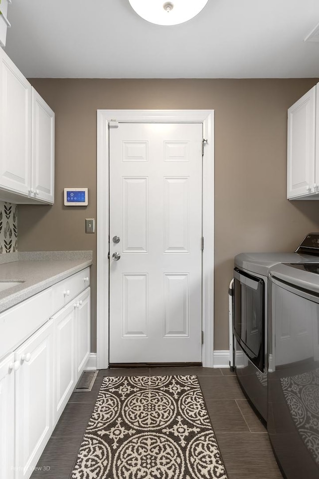18089 W Pond Ridge Cir, Gurnee, IL 60031 - laundry room with cabinet space, independent washer and dryer, baseboards, and dark tile patterned floors