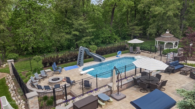 18089 W Pond Ridge Cir, Gurnee, IL 60031 - view of swimming pool featuring a water slide, a gazebo, an outdoor fire pit, and a patio area
