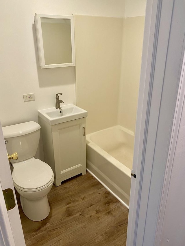 910 Market St, Dekalb, IL 60115 - bathroom with vanity, wood finished floors, and toilet