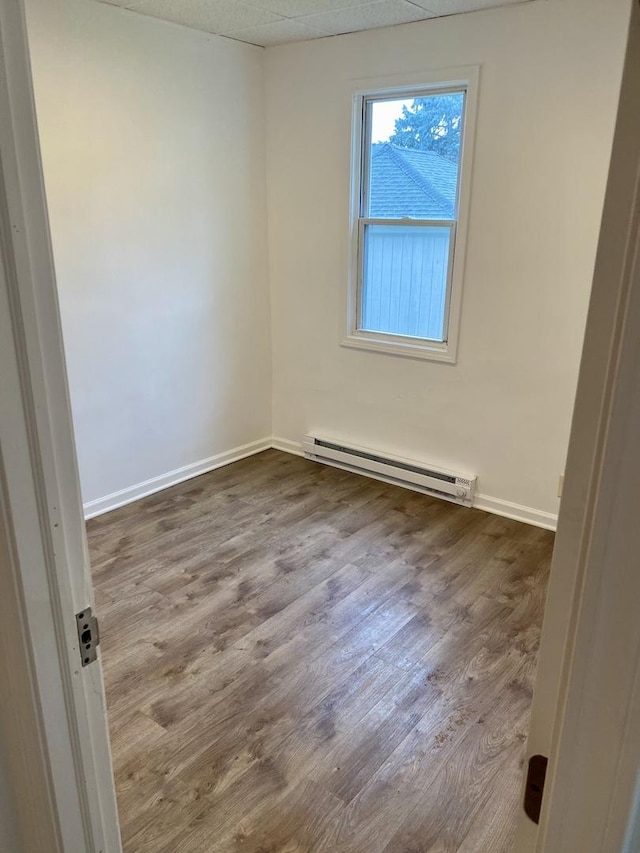 910 Market St, Dekalb, IL 60115 - empty room featuring a baseboard radiator, dark wood-style floors, and baseboards