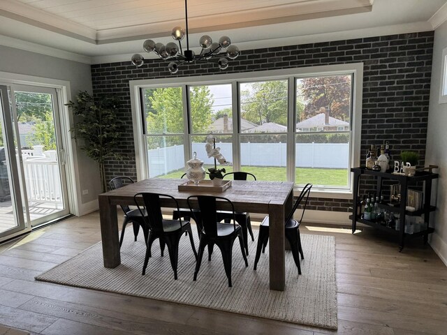 35 E Woodworth Pl, Roselle, IL 60172 - dining area with hardwood / wood-style flooring, crown molding, a chandelier, and brick wall