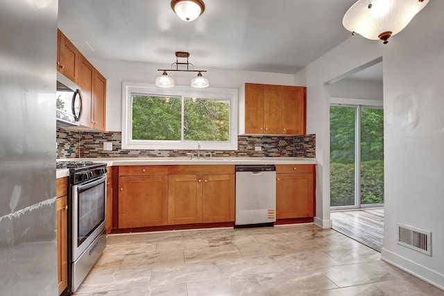 300 Redwing Dr, Bolingbrook, IL 60440 - kitchen with appliances with stainless steel finishes, light countertops, and brown cabinets