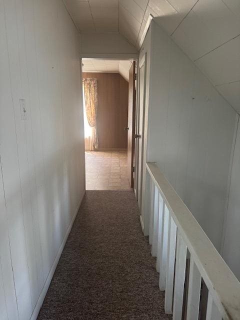 303 W Prairie St, Pontiac, IL 61764 - hallway featuring vaulted ceiling, carpet flooring, and wooden walls
