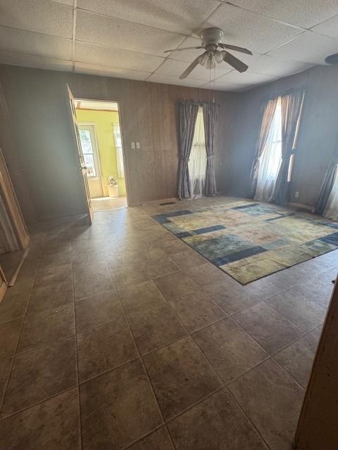 303 W Prairie St, Pontiac, IL 61764 - spare room featuring a paneled ceiling, ceiling fan, and healthy amount of natural light