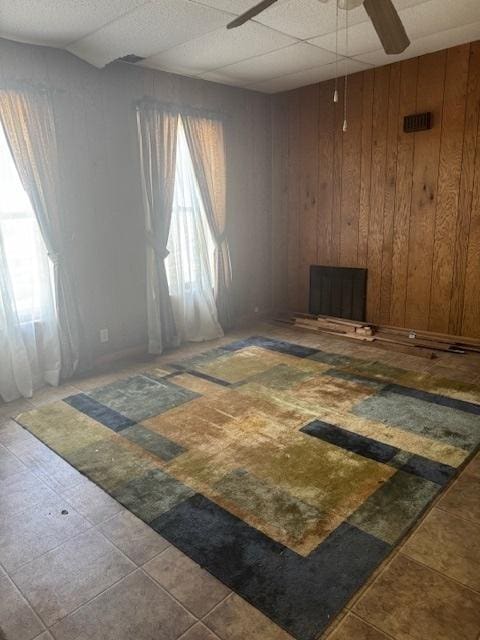 303 W Prairie St, Pontiac, IL 61764 - spare room with a ceiling fan and wood walls