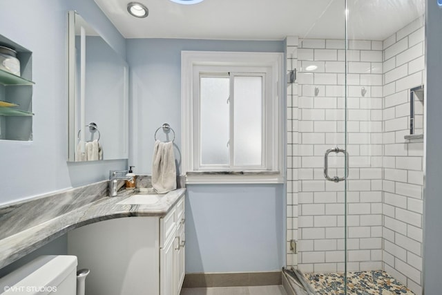 4253 Grove St, Skokie, IL 60076 - full bathroom with toilet, vanity, a shower stall, and baseboards
