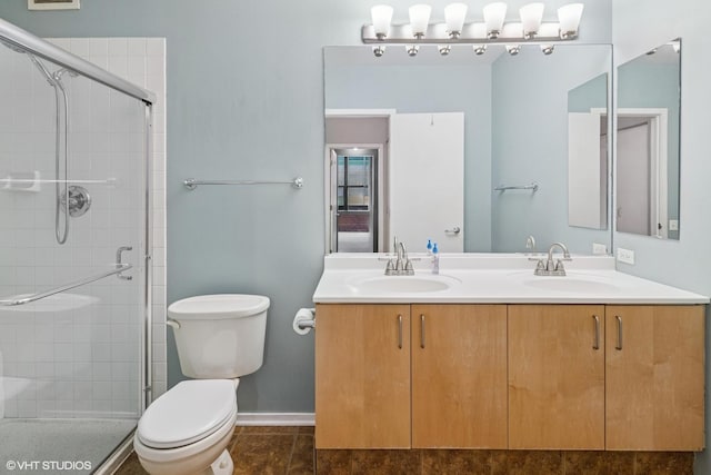 130 S Canal St Unit 216, Chicago, IL 60606 - bathroom with toilet, a shower stall, double vanity, baseboards, and tile patterned flooring