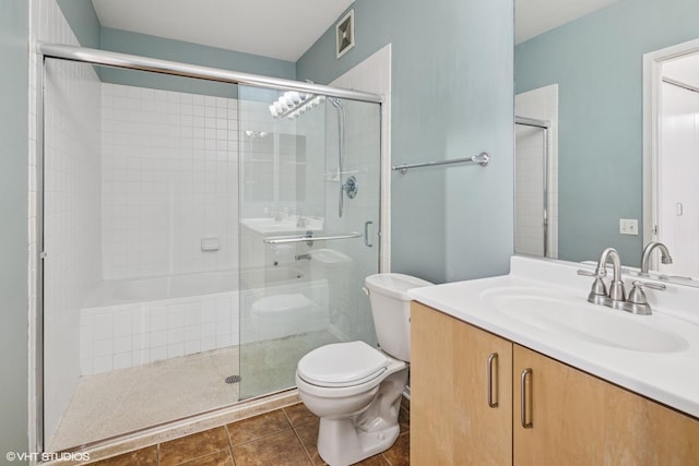 130 S Canal St Unit 216, Chicago, IL 60606 - bathroom with toilet, a tile shower, vanity, and tile patterned floors