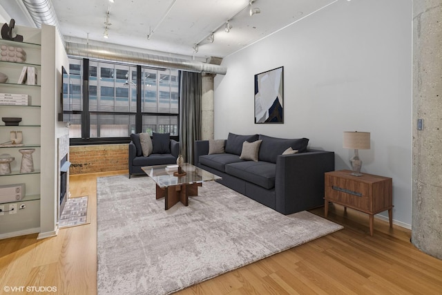 130 S Canal St Unit 216, Chicago, IL 60606 - living area with track lighting, wood finished floors, and baseboards