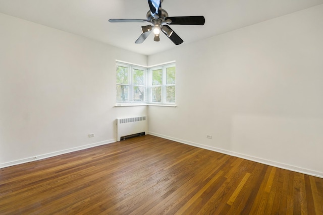 unfurnished room featuring radiator, ceiling fan, baseboards, and wood-type flooring