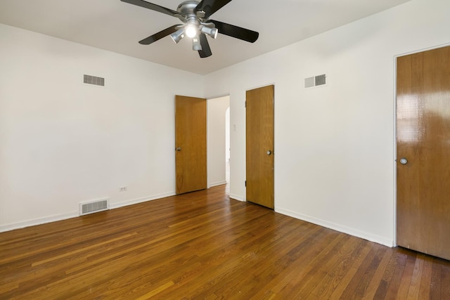 unfurnished bedroom with wood finished floors, baseboards, and ceiling fan