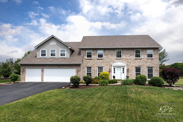 1309 Brunswick Ct, Naperville, IL 60540 - colonial-style house featuring roof with shingles, an attached garage, driveway, brick siding, and a front lawn