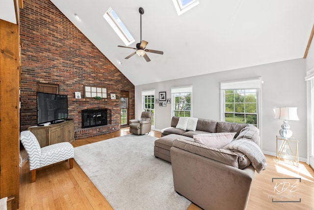 1309 Brunswick Ct, Naperville, IL 60540 - living room featuring high vaulted ceiling, a skylight, wood finished floors, a brick fireplace, and ceiling fan