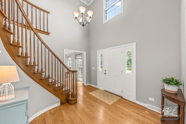 1309 Brunswick Ct, Naperville, IL 60540 - foyer with a chandelier, wood finished floors, a towering ceiling, healthy amount of natural light, and baseboards