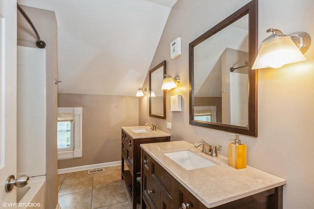 523 Spruce St, Aurora, IL 60506 - bathroom with lofted ceiling, two vanities, baseboards, a shower, and tile patterned flooring