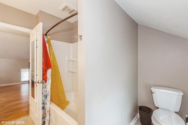 523 Spruce St, Aurora, IL 60506 - full bathroom with wood finished floors, toilet, shower / tub combo, and baseboards