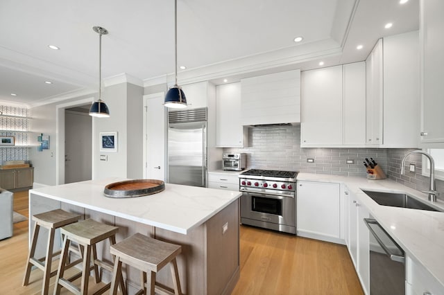 736 W Melrose St Unit 4W, Chicago, IL 60657 - kitchen featuring premium appliances, a sink, premium range hood, tasteful backsplash, and light wood-style flooring