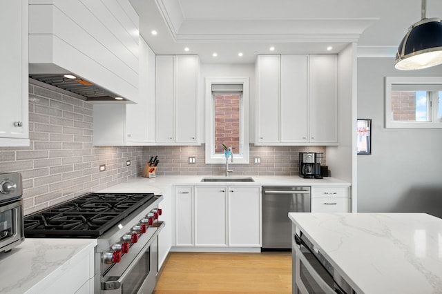 736 W Melrose St Unit 4W, Chicago, IL 60657 - kitchen with a sink, appliances with stainless steel finishes, wall chimney range hood, backsplash, and crown molding