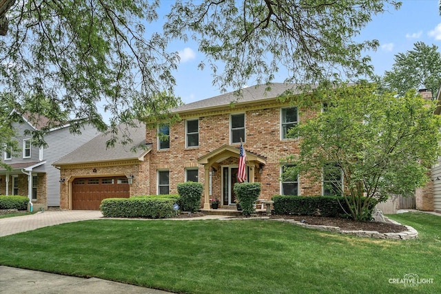 2255 University Dr, Naperville, IL 60565 - colonial home featuring brick siding, a garage, driveway, a front lawn, and a shingled roof