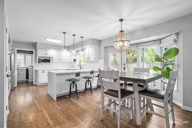 2255 University Dr, Naperville, IL 60565 - dining area with a chandelier, plenty of natural light, dark wood-type flooring, and baseboards